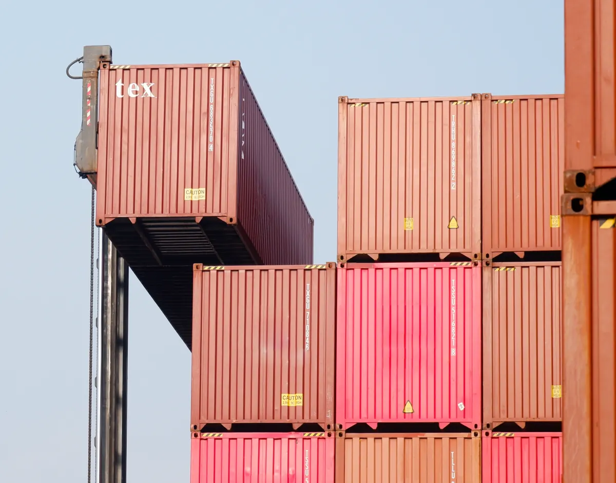 Shipping containers being stacked at a port terminal