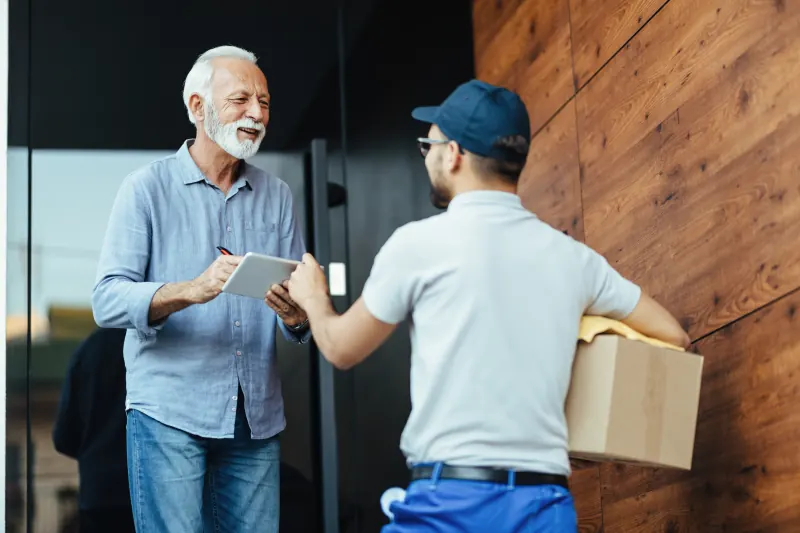 Courier handing a package to a customer